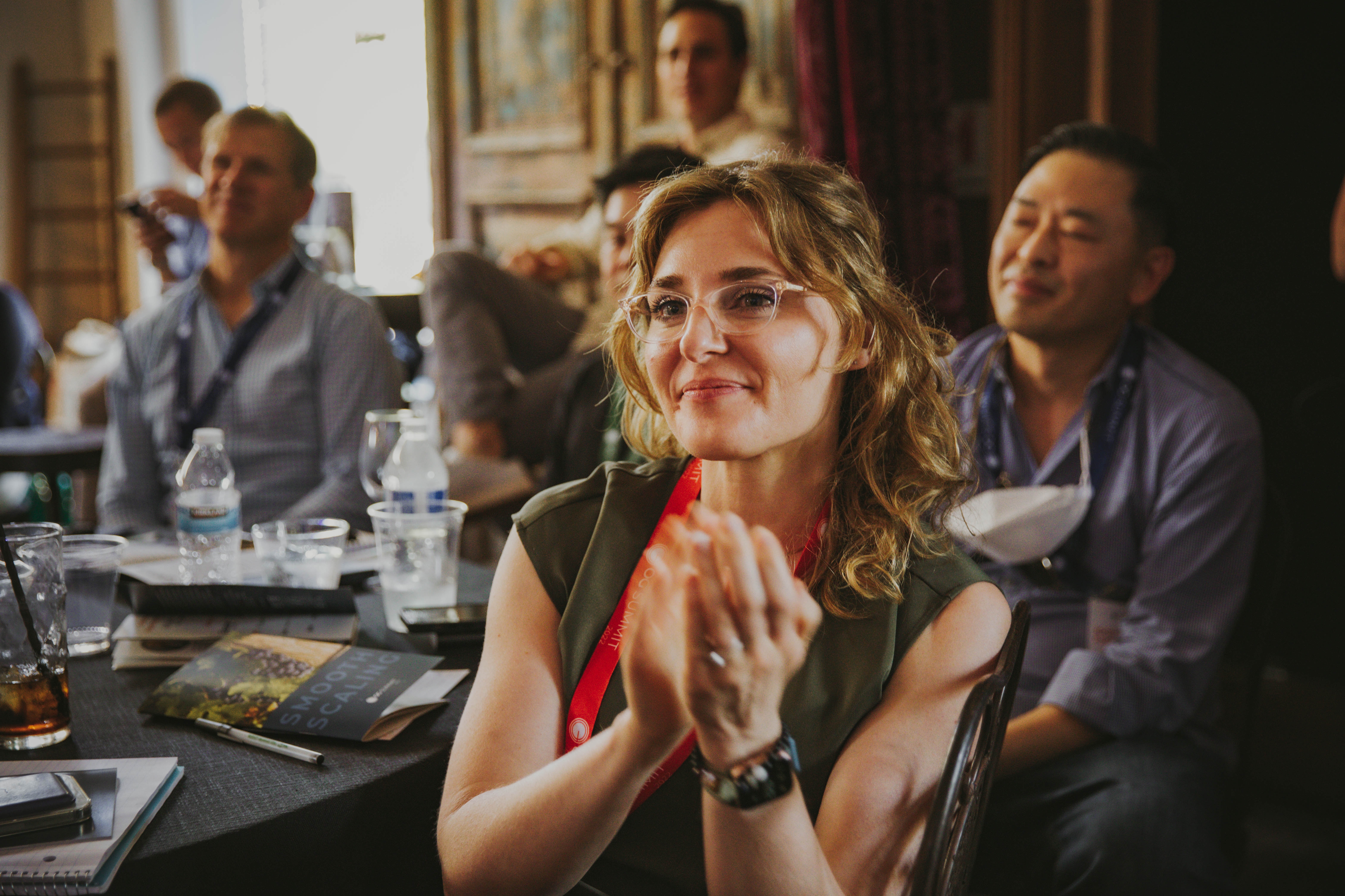 Attentive participant applauding at Copenhagen FinTech Week, engaging with financial technology trends and leaders.