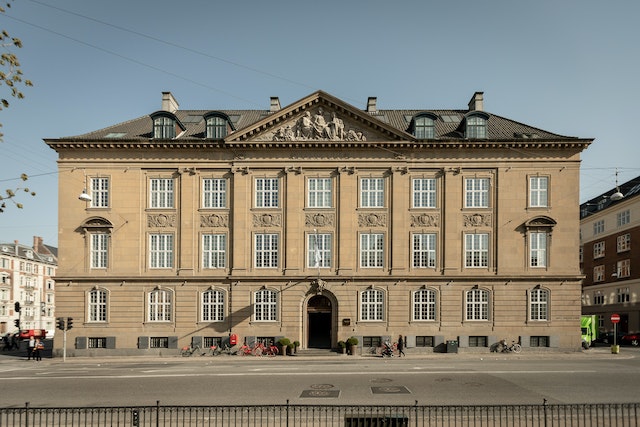 Elegant facade of Nobis Hotel in Copenhagen with classic European architecture and clear blue sky backdrop.