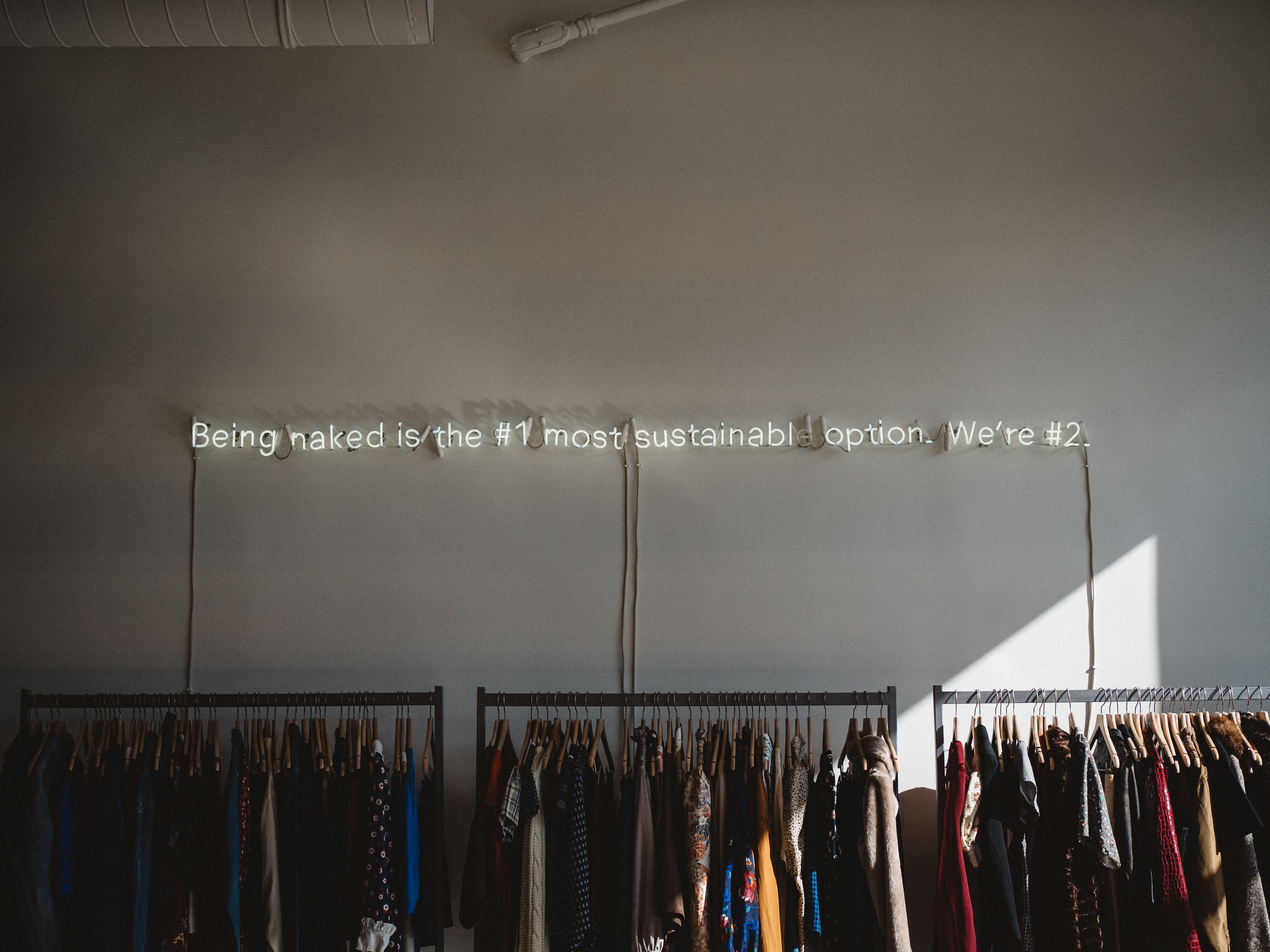 Creative sustainability message in a clothing store, resonating with themes from Sustainable Brands Copenhagen event on driving change through sustainability.